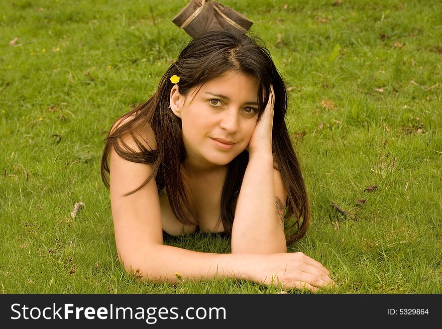 Attractive woman lying in a meadow on a summers day