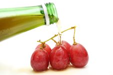Wine Pour On Grapes Stock Photo