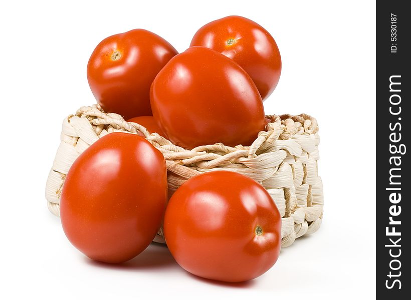 Fresh tomatoes in basket isolated on a white background. Fresh tomatoes in basket isolated on a white background.