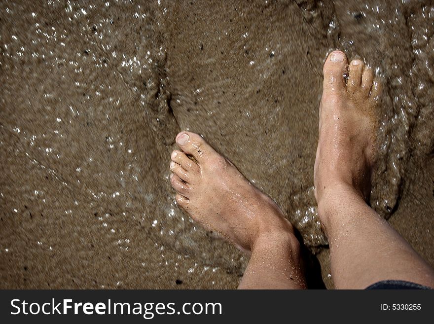 An image of feet in the mud in movement.