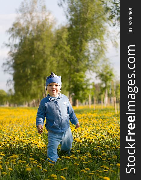 A Cute Child Walking On Sunny Meadow