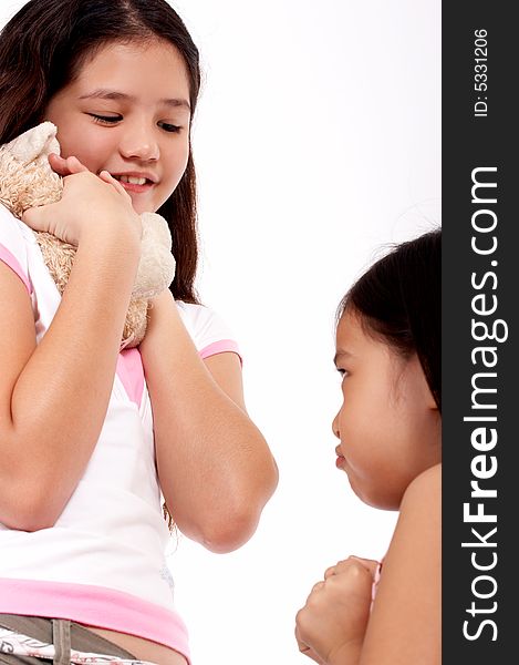 Smiling young girl holding a cute cuddly toy