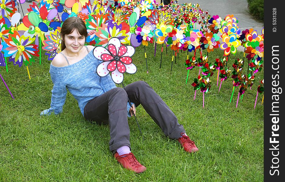 A portrait of a beautiful young girl holding a pinwheel. A portrait of a beautiful young girl holding a pinwheel