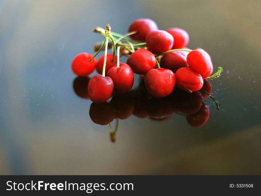 Some cherries with mirror reflection