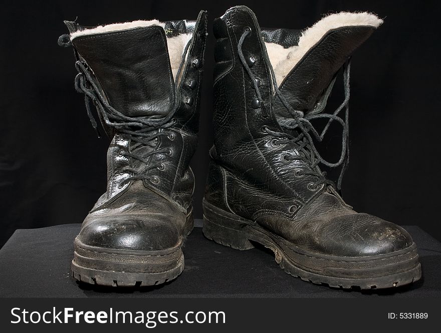 A pair of black thicket boots on a black background. A pair of black thicket boots on a black background