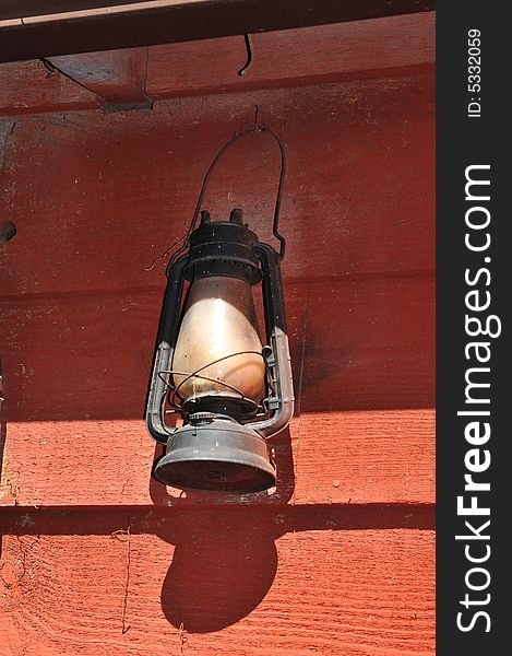 Lit Antique oil lamp against a grungee background