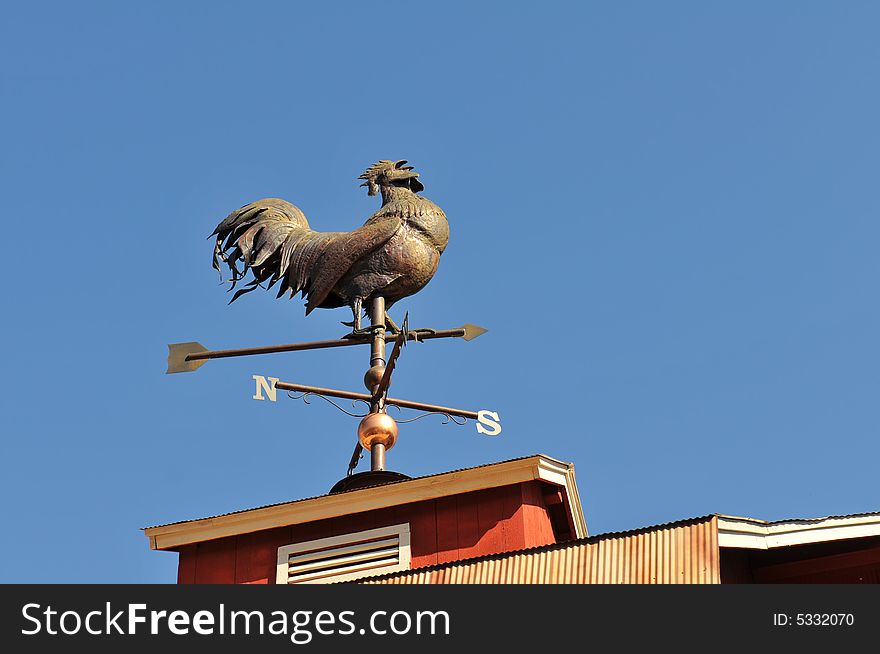 Weathervane shaped like a rooster against clear sky. Weathervane shaped like a rooster against clear sky