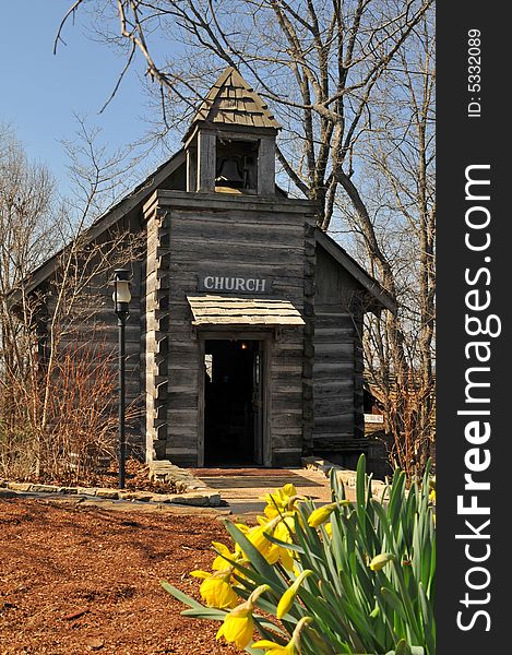 Olr rural wooden church with flowers on a sunny day. Olr rural wooden church with flowers on a sunny day