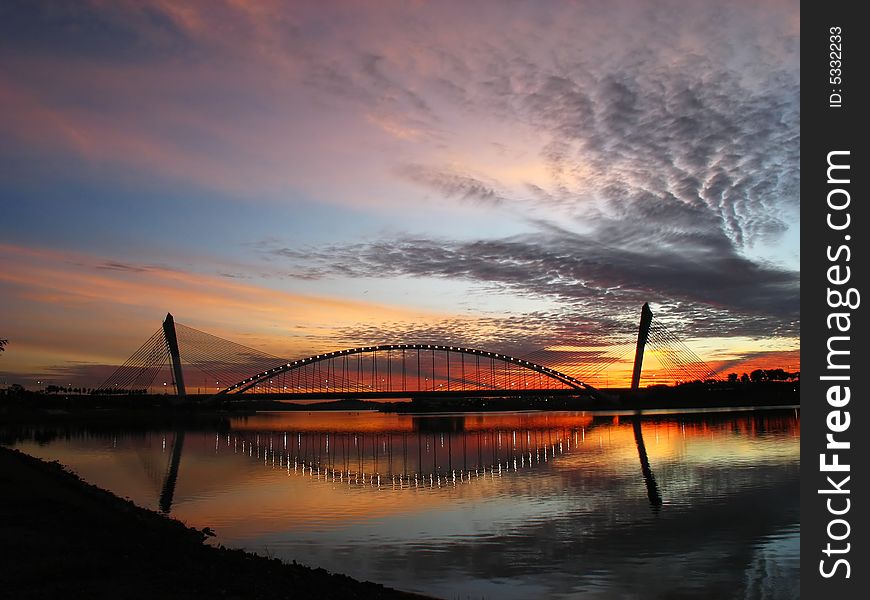 Bridge and reflections with sunset background. Bridge and reflections with sunset background