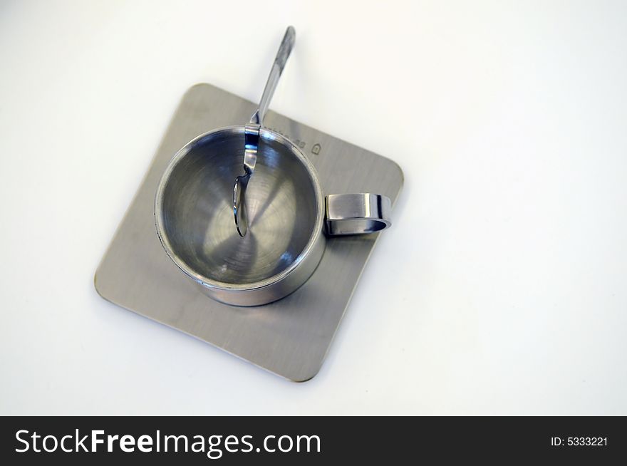The shiny stainless steel plate , spoon and cup for drinking. The shiny stainless steel plate , spoon and cup for drinking.