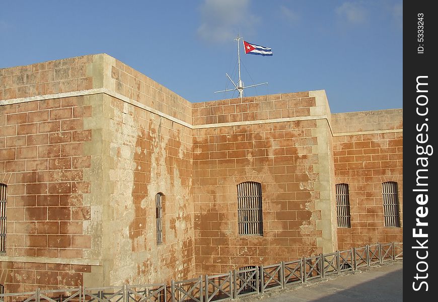 The Morro bricks wall and a cuban flag