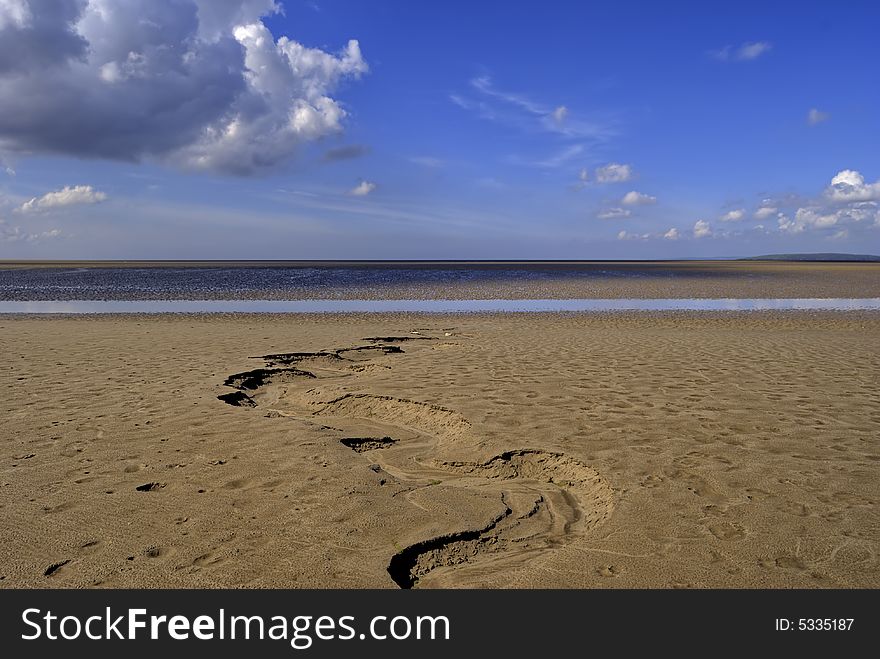 Sand at low tide in the Morcambe Bay estuary at low tide. Sand at low tide in the Morcambe Bay estuary at low tide