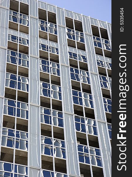 A new high rise office or condo building with windows installed. A new high rise office or condo building with windows installed