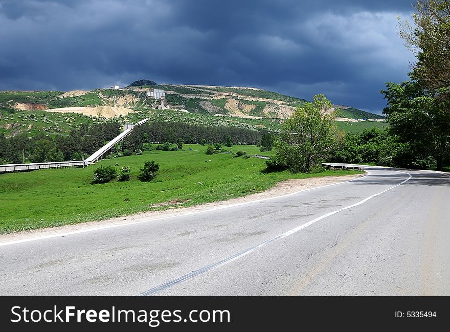 A road is taking us to the mountains and the storm is coming