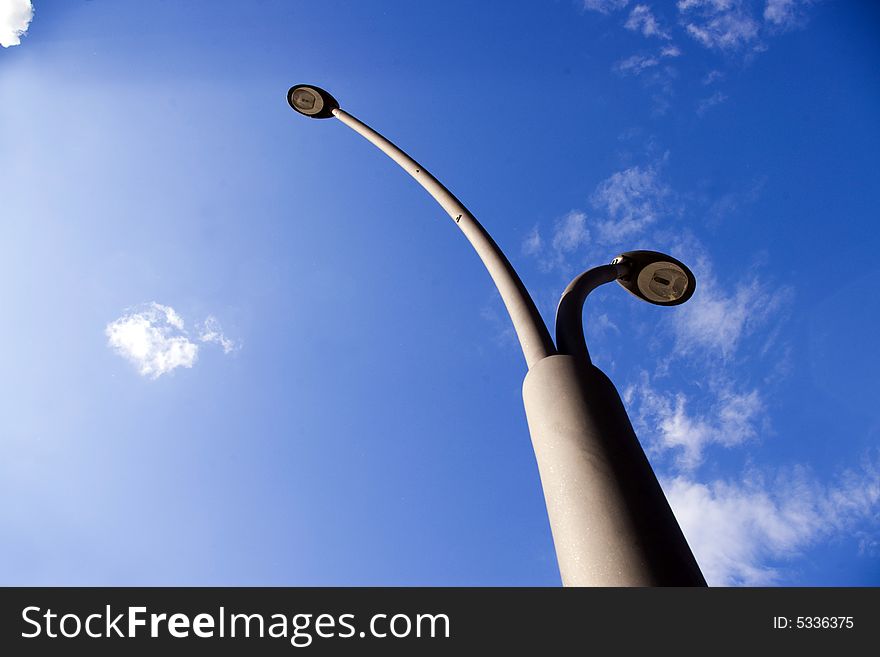 Street lamps towards blue sky. Street lamps towards blue sky