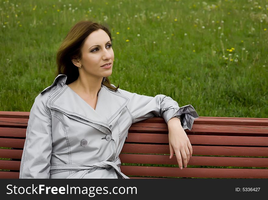 Young Woman Sitting On The Bench. Young Woman Sitting On The Bench
