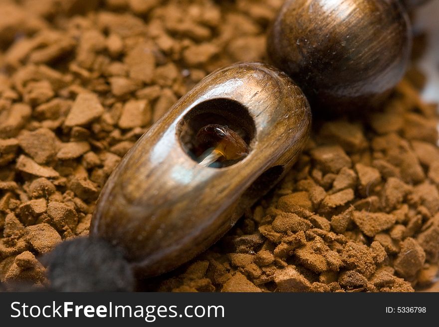 Aromatic instant coffee and wooden decoration with amber macro