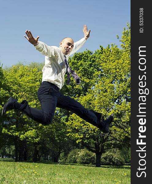 Jumping businessman in the park. Jumping businessman in the park.