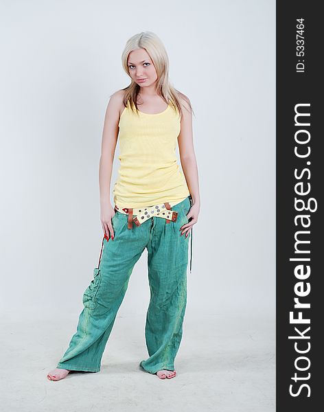 Pretty young girl dressed in yellow shirt and green knickerbockers. Pretty young girl dressed in yellow shirt and green knickerbockers