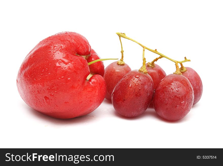Water apple and red grape on white background.