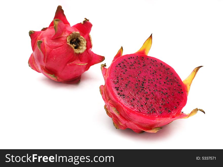 An half and full red dragon fruits over white background.