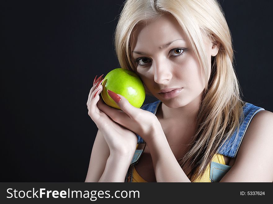 The person of the beautiful girl with a green apple in a hand and red manicure. The person of the beautiful girl with a green apple in a hand and red manicure