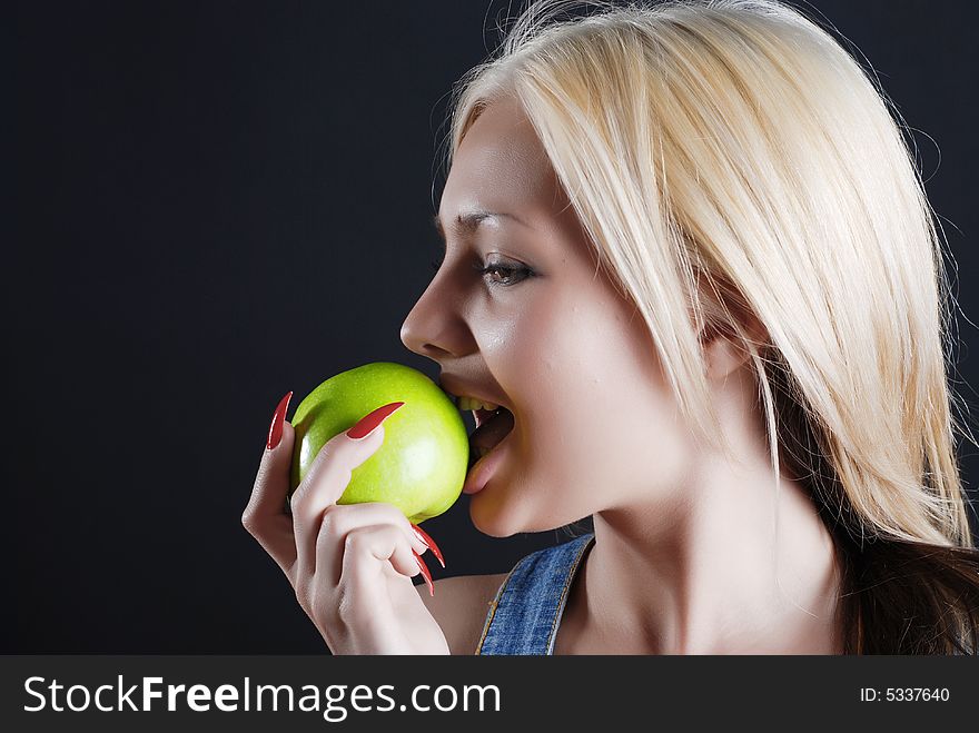 The person of the beautiful girl with a green apple in a hand and red manicure. The person of the beautiful girl with a green apple in a hand and red manicure