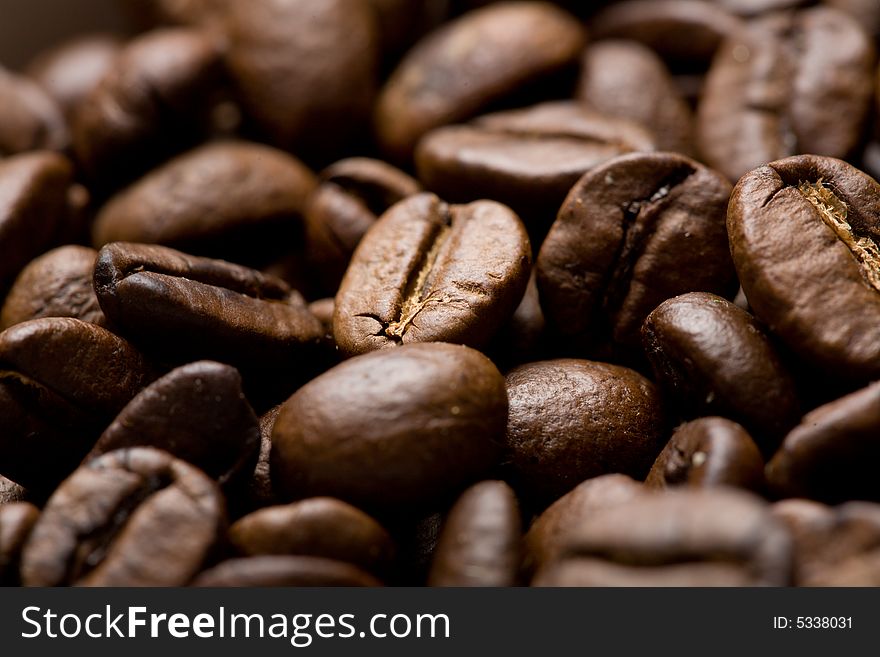 Freshly roasted coffee beans on sackcloth Shallow depth of field. Focus on center of image