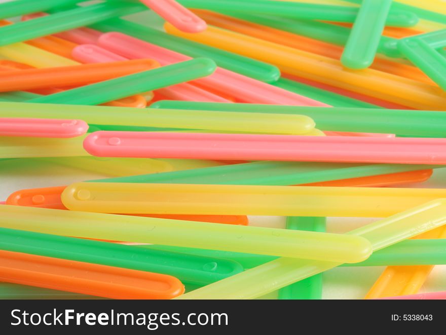 Heap of color sticks of yellow, orange, green and red colors form a background