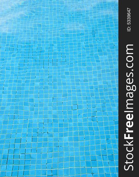 An image of the blue bottom of a swimming pool  distorted by water. An image of the blue bottom of a swimming pool  distorted by water