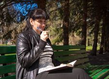 Beautiful Woman Sitting On A Park Bench Holding A Pen And Notebo Royalty Free Stock Image Beautiful Woman Sitting On A Park Bench Holding A Pen And Notebo Royalty Free Stock Image