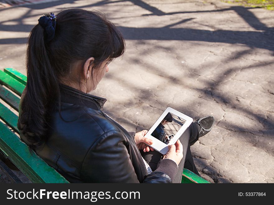 Young beautiful woman looking at a photo on the tablet