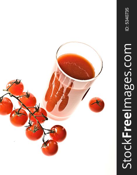 Food series: branch of red tomato over white with juice. Food series: branch of red tomato over white with juice