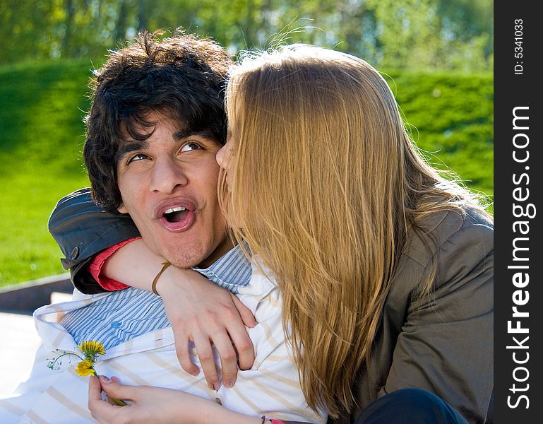 Happy pair of lovers embrace and kiss in the park. Happy pair of lovers embrace and kiss in the park