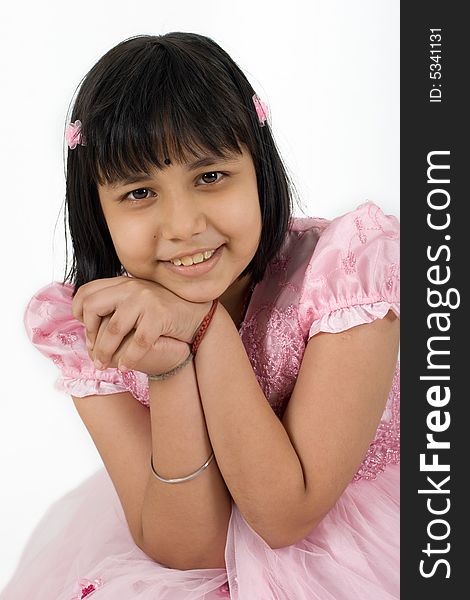 Young Asian girl in pink dress striking a pose for camera. Young Asian girl in pink dress striking a pose for camera