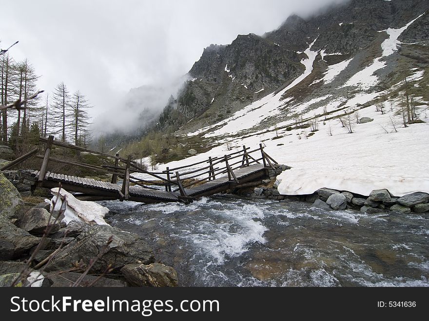 Arpy lake in morgex, aosta, with snow covered surface under incomings clouds, 1st june 2008. Arpy lake in morgex, aosta, with snow covered surface under incomings clouds, 1st june 2008