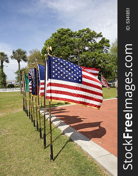 A line of historic american flags in a display at a park. A line of historic american flags in a display at a park