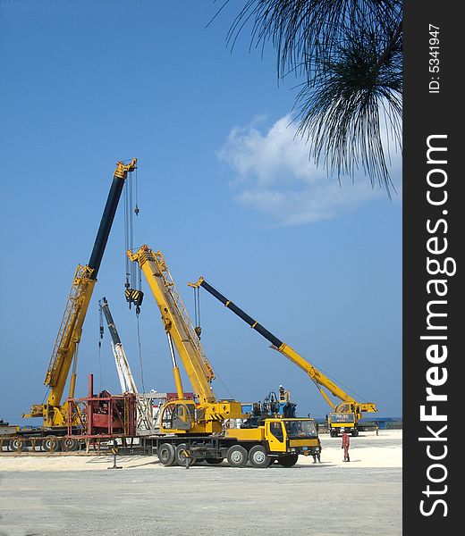 Four cranes truck working at an oil plant. Four cranes truck working at an oil plant