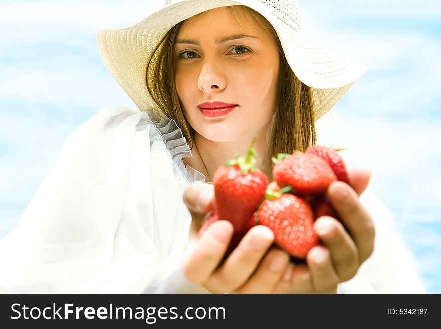 Beautiful young woman in hat with strawberry. Beautiful young woman in hat with strawberry