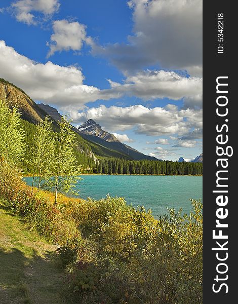 Northern lake surrounded by a wood and mountains in Canada. Northern lake surrounded by a wood and mountains in Canada