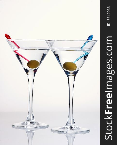 Two martini glasses with olive on white background. Two martini glasses with olive on white background