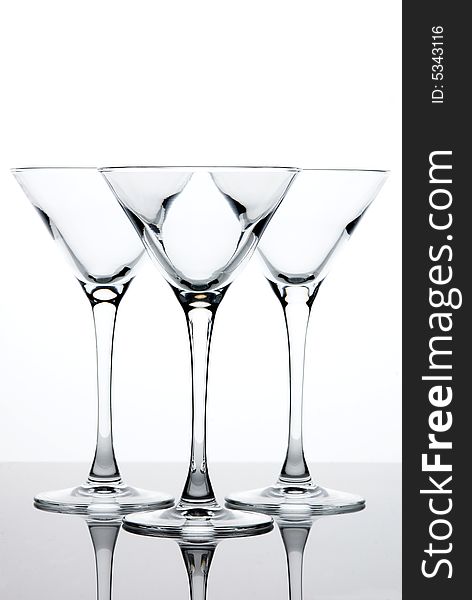 Three empty martini glasses on white background