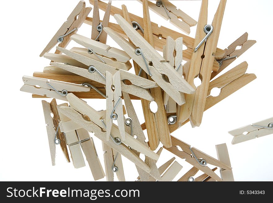 Pile of isolated wooden clothespins. Pile of isolated wooden clothespins