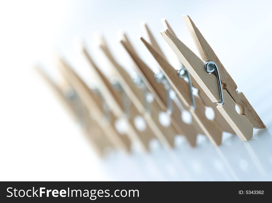 Seven isolated wooden clothespins in a row. Seven isolated wooden clothespins in a row