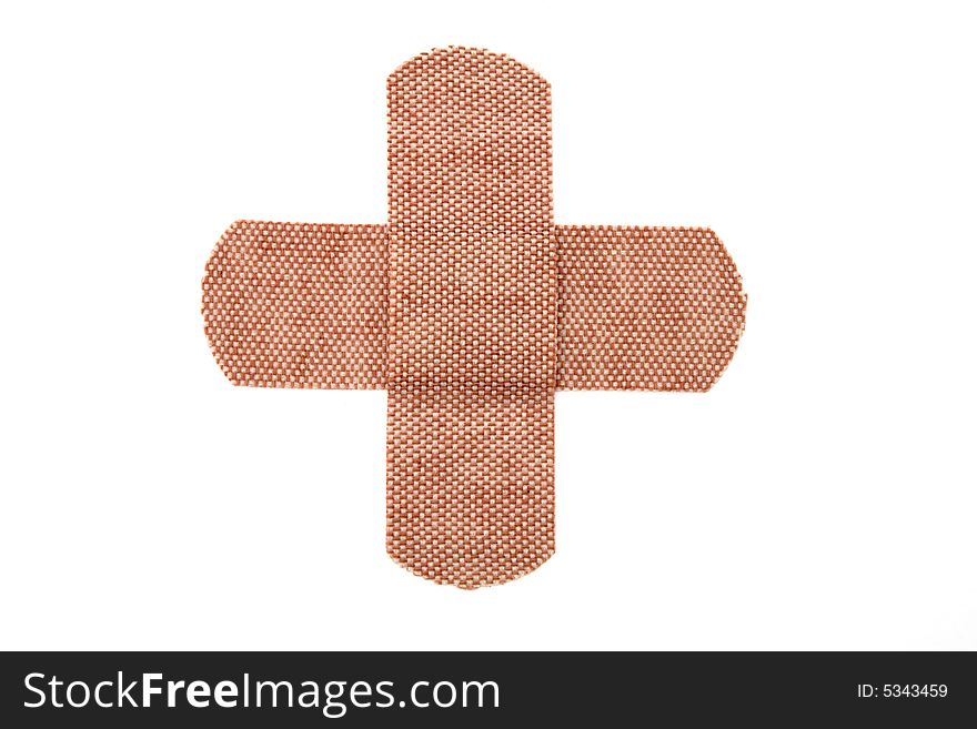 Bandages forming a cross isolated on white