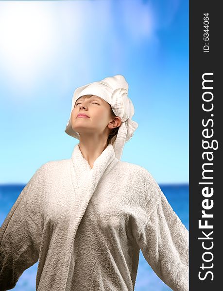 A woman with a bathrobe at sea. A woman with a bathrobe at sea