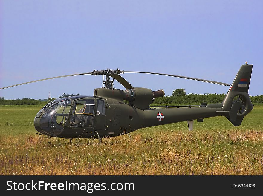 Military helicopter standing on the airfield.