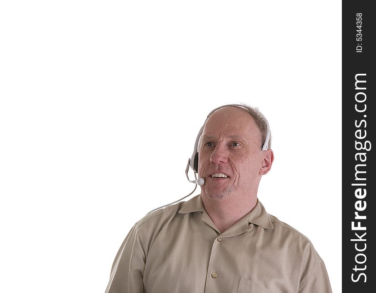 A man in brown shirt on white background with a telephone headset looking up. Tech Support or a telemarketer. A man in brown shirt on white background with a telephone headset looking up. Tech Support or a telemarketer