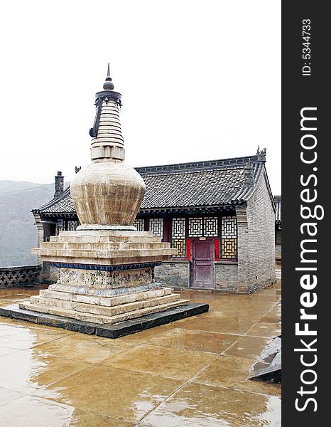 Tower in the ancient temple. 
This tower has already had a history of a thousand years.

Chinese characters on the door of background and both sides are a text of Buddhism.