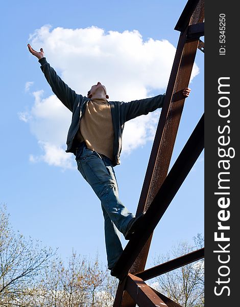 Man against a background of blue sky and clouds